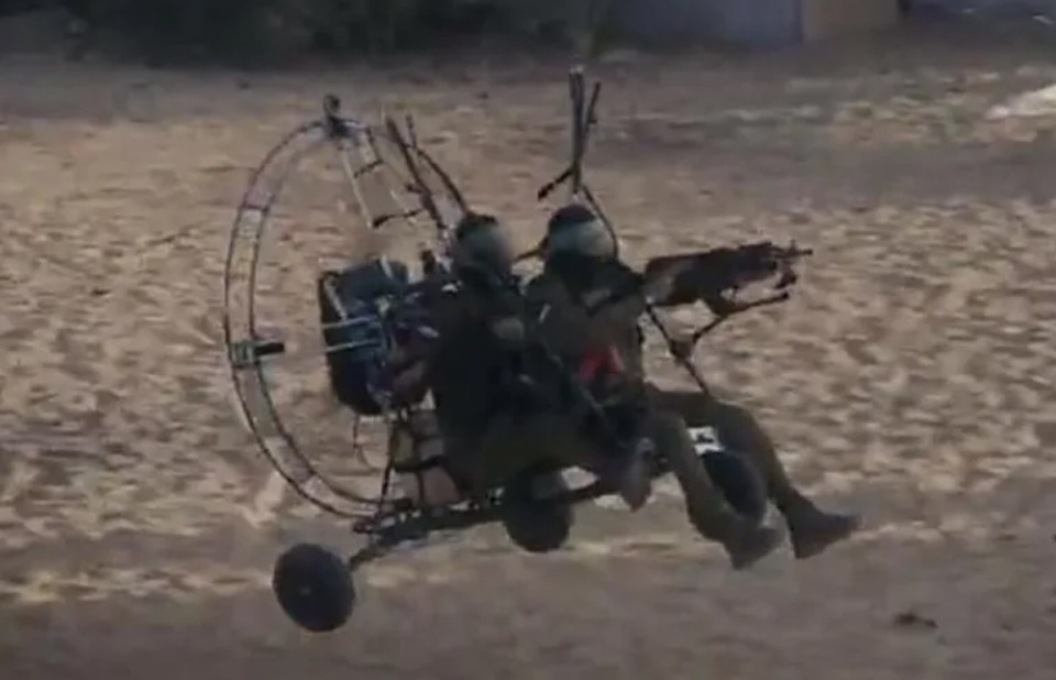 Hamas float over the heavily-fortified border with Israel using motorised paragliders